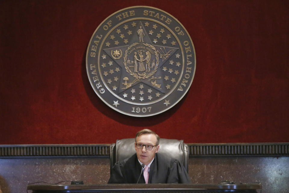 Judge Thad Balkman announces his decision in the Opioid Lawsuit In Norman, Okla., Monday, Aug. 26, 2019. Balkman found Johnson & Johnson and its subsidiaries helped fuel the state's opioid drug crisis and ordered the consumer products giant to pay $572 million to help abate the problem in the coming years. (AP Photo/Sue Ogrocki, Pool)