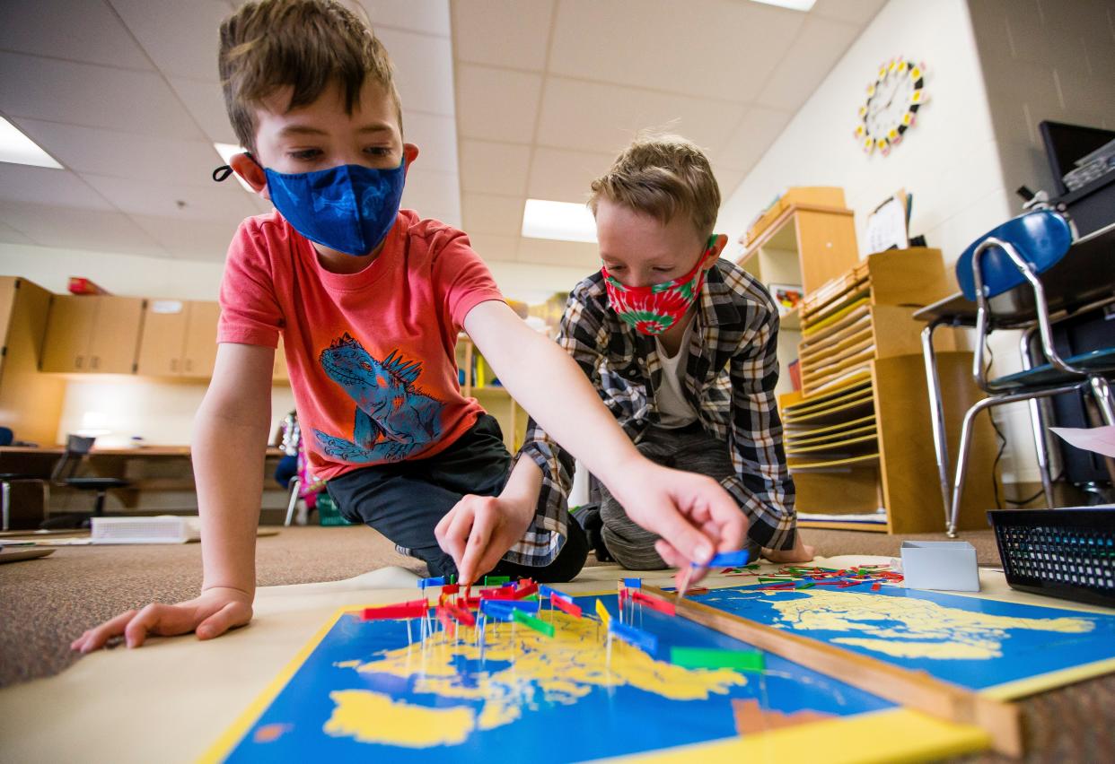 Jackson Rose, 8, left, and Oliver Vincent, 9, work on a geography assignment in February 2021 at Marquette Montessori Academy in South Bend. Marquette is one of several schools contracted to work with educational services company, Learning Services International, to help improve students' academic performance.