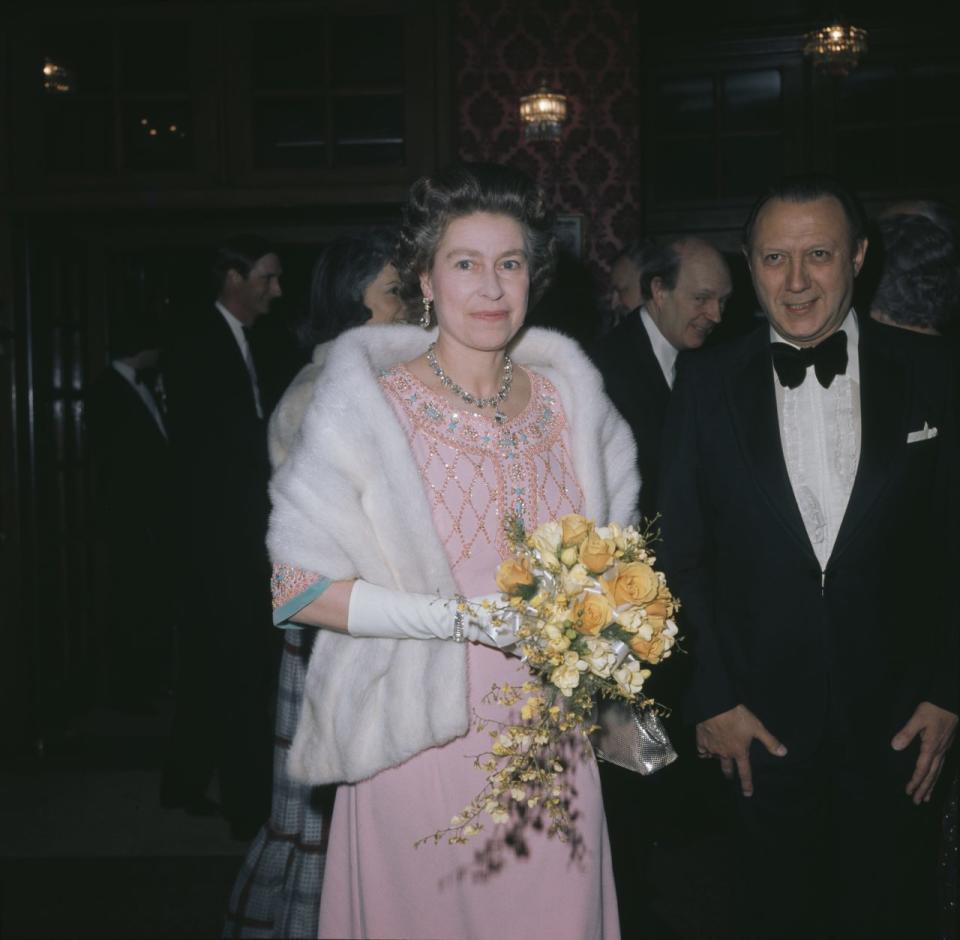 Queen Elizabeth II wearing a pink beaded evening gown and a white fur stole, circa 1975. (Photo by Keystone/Hulton Archive/Getty Images)