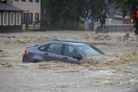 <p>A parked car is flooded in a lot near Main Street and Ellicott Mills Road as a heavy storm caused flash flooding at historic Ellicott City. (Photo: Kenneth K. Lam/The Baltimore Sun via AP) </p>