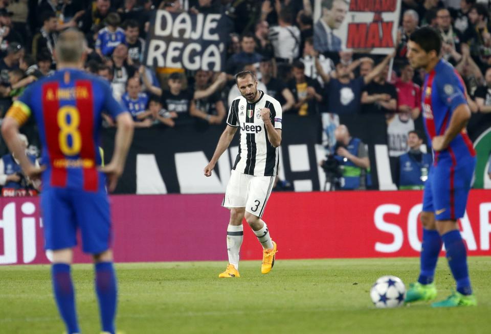 Juventus's Giorgio Chiellini, center, celebrates after scoring his side's third goal during a Champions League, quarterfinal, first-leg soccer match between Juventus and Barcelona, at the Juventus Stadium in Turin, Italy, Tuesday, April 11, 2017. (AP Photo/Antonio Calanni)