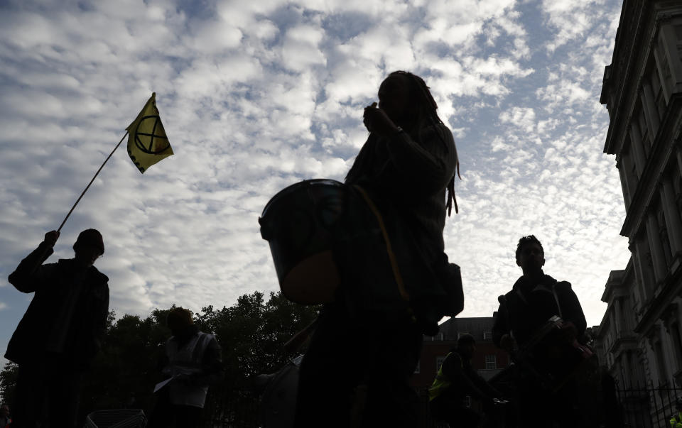 Climate change protesters play their drums at the rear of Downing Street in London, Tuesday, Oct. 8, 2019. Police are reporting they have arrested more than 300 people at the start of two weeks of protests as the Extinction Rebellion group attempts to draw attention to global warming. (AP Photo/Alastair Grant)