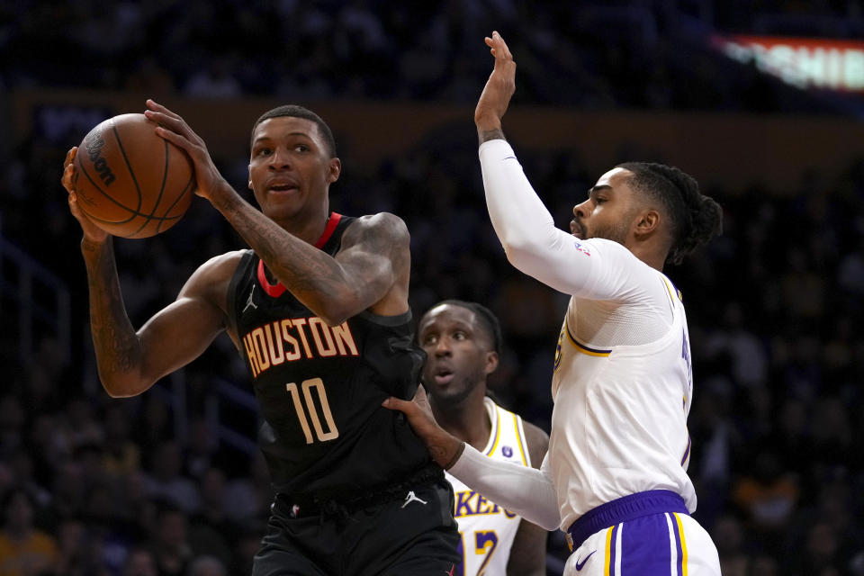 Houston Rockets forward Jabari Smith Jr. (10) goes to the basket against Los Angeles Lakers guard D'Angelo Russell, right, and forward Taurean Prince (12) during the first half of an NBA basketball game in Los Angeles, Sunday, Nov. 19, 2023. (AP Photo/Eric Thayer)
