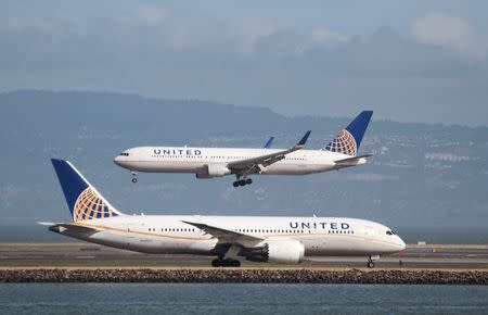 A United Airlines Boeing 787 taxis as a United Airlines Boeing 767 lands at San Francisco International Airport, San Francisco, California, February 7, 2015. REUTERS/Louis Nastro