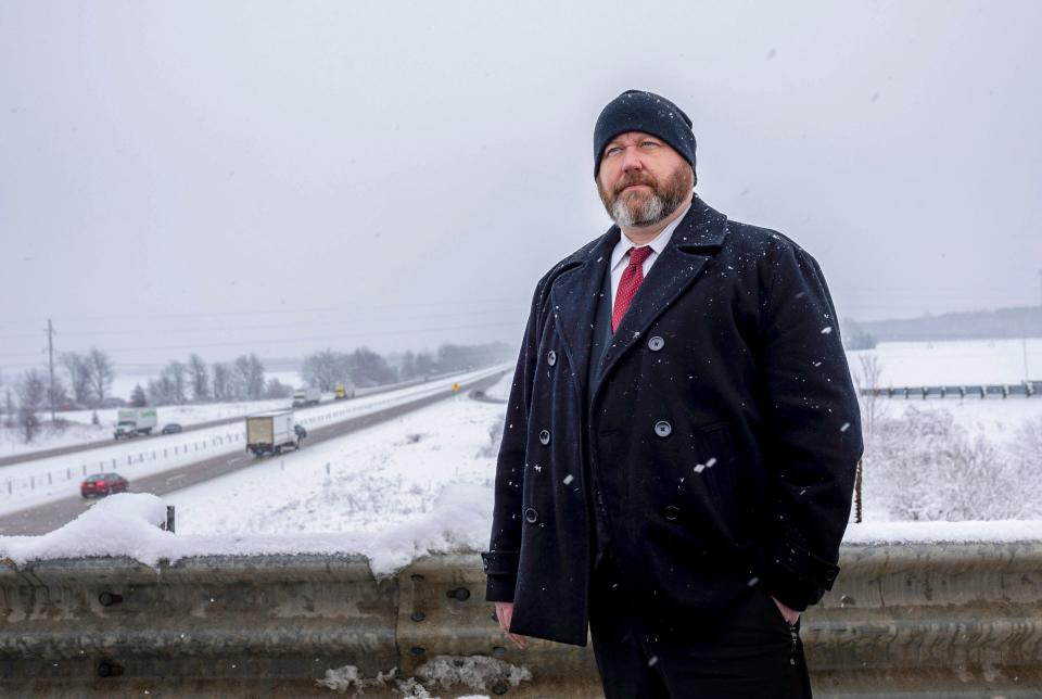 Phillip Hesche, 44, an Ionia County Sheriff's Office detective sergeant, stands on an overpass in Saranac on Thursday, Jan. 11, 2024. Hesche was the detective that showed up on the scene after Amedy Dewey was shot in the face. "It happened around January and it was dead dry cold, Hesche said. "I couldn't fathom what was so bad that he would shoot his wife in the face and then shoot his stepdaughter in the face and then turn the gun to himself and shoot himself."