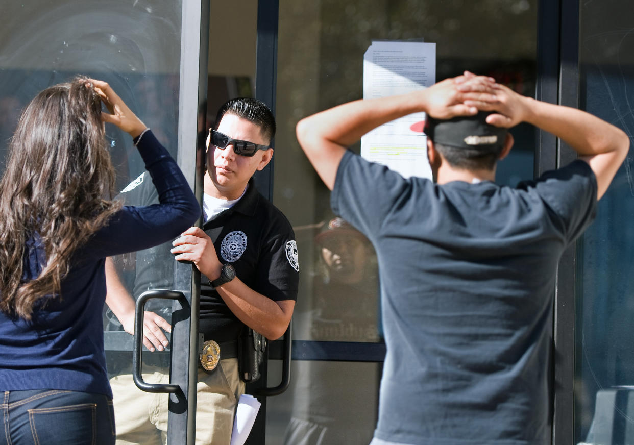 SANTA ANA, CA - APRIL 27: A security guard inside Everest College keeps away a member of the media and a former student Gary Montano after the embattled for-profit Santa Ana school was shut down along with 28 others on Monday. Montano, 30 who graduated two years ago, was trying to collect his transcripts and diploma. "Now I can't walk in. You'd think they'd want to help me out to clear their name," he said.        ///ADDITIONAL INFORMATION:  √ê 4/27/15 √ê MINDY SCHAUER,  -  corinthian.0428  shot:042715  Corinthian Colleges Inc. shuts down its remaining 28 for-profit career schools, including Everest in Santa Ana, ending classes for about 16,000 students, in the biggest collapse in U.S. higher education.    (Photo by Mindy Schauer/Digital First Media/Orange County Register via Getty Images)