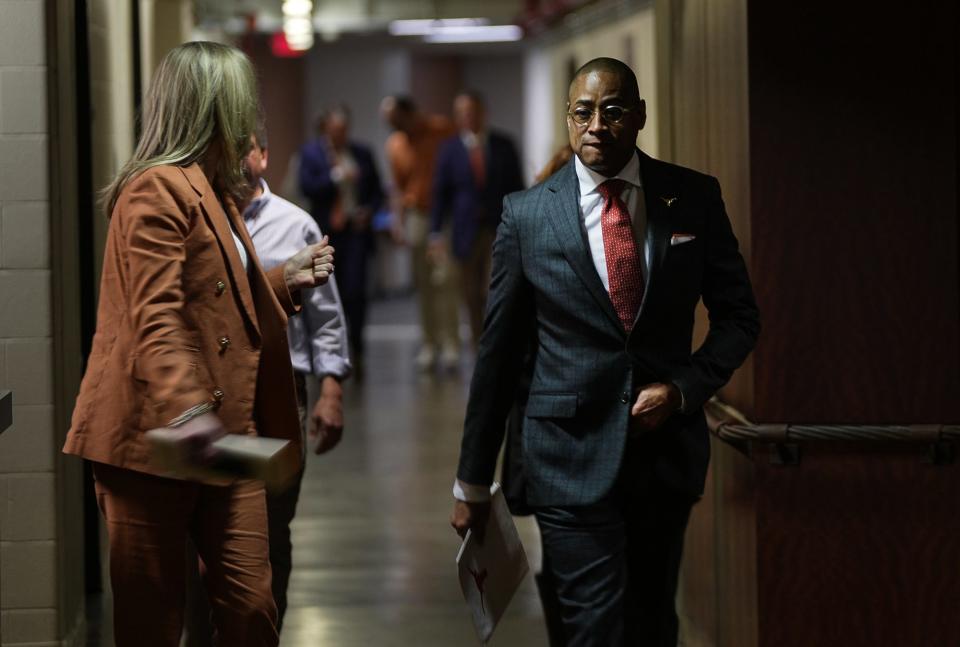 Texas head coach Rodney Terry makes his way into Tuesday's press conference. “We are here today because a whistle was given to you on Dec. 12, but you took that whistle and you earned it,” UT athletic director Chris Del Conte said to Terry, who had worn an acting or interim coaching tag until Monday.