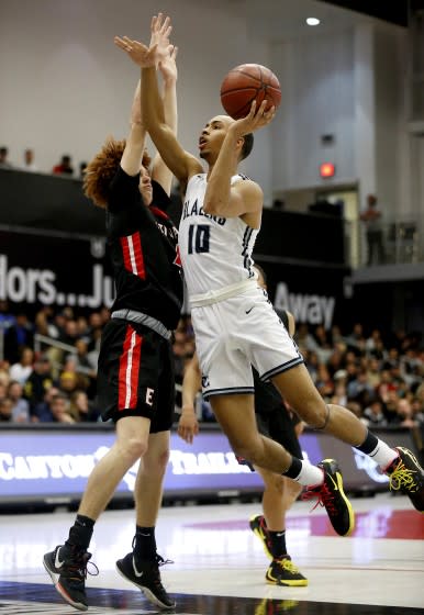 Amari Bailey (10) of Sierra Canyon drives to the basket guarded by Brantly Stevenson (4) of Etiwanda.