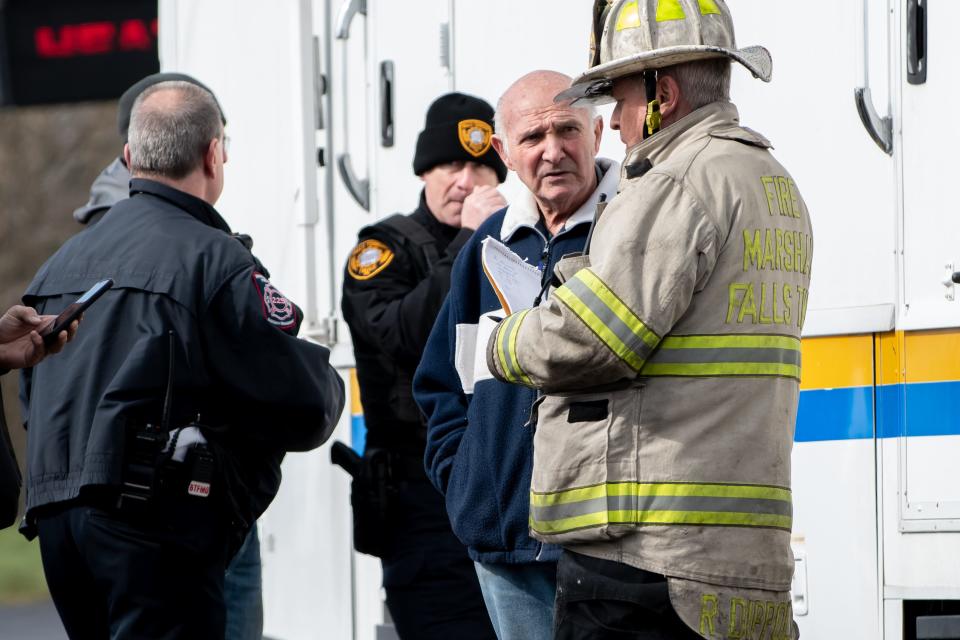 Allen Episcopo, owner of Levittown Lanes, speaks with Falls Township Fire Marshal Rich Dippolito, as crews work on the scene of a three-alarm fire that destroyed his Falls bowling alley in the early morning hours of Wednesday, March 30, 2022.