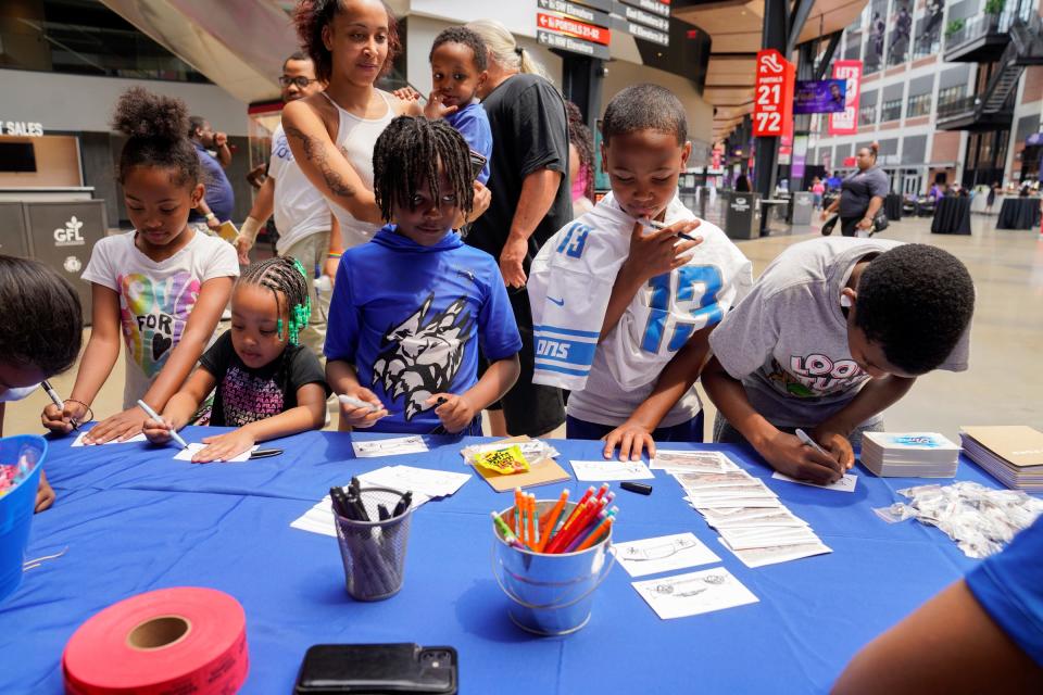 Kids at the Culture Empowerment Day event design cars at the Ford Motor Co. pop-up in Detroit at Little Caesars Arena on Sunday, June 25, 2023. The event was hosted by Culture Academy and featured live panels, live music, workshops and games.