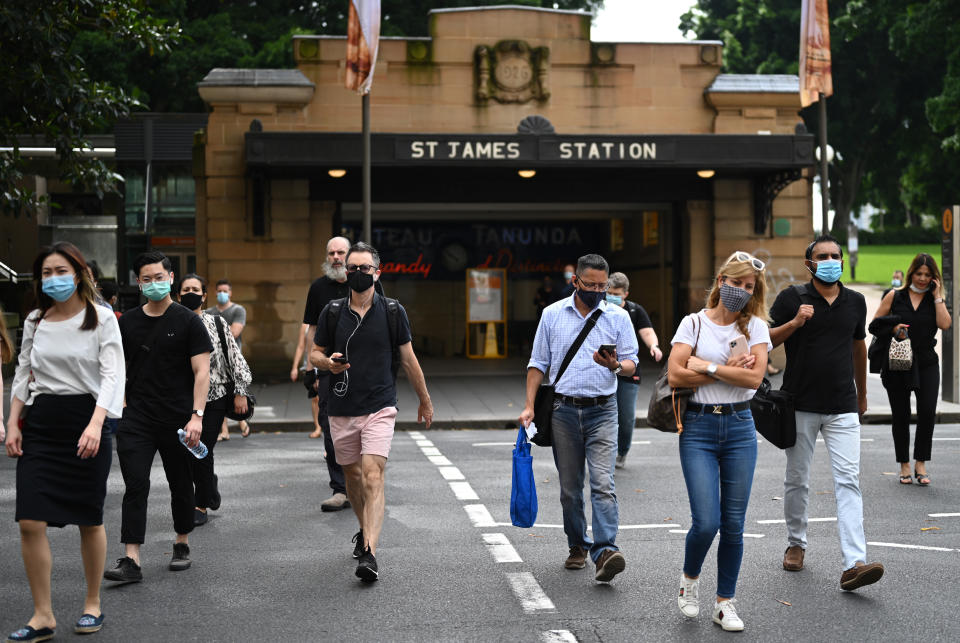 Commuters wearing face masks exit St. James Station in the CBD in Sydney on January 4. Source: AAP