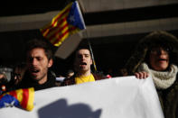 Pro independence demonstrators gather outside the Spanish Supreme Court in Madrid, Tuesday, Feb. 12, 2019. Spain is bracing for the nation's most sensitive trial in four decades of democracy this week, with a dozen Catalan separatists facing charges including rebellion over a failed secession bid in 2017. (AP Photo/Andrea Comas)