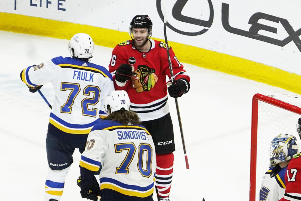 Chicago Blackhawks center Jason Dickinson (16) celebrates his goal in front of St. Louis Blues defenseman Justin Faulk (72) during the second period of an NHL hockey game Saturday, Dec. 9, 2023, in Chicago. (AP Photo/David Banks)