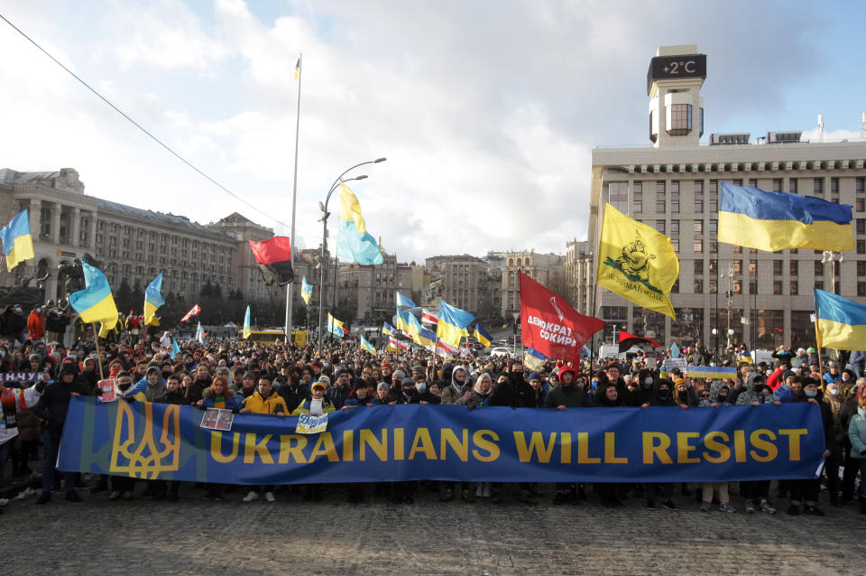 Protesters in Kyiv, Ukraine, hold a banner and flags as they take part in a rally against escalation of the tension between Russia and Ukraine on Feb. 12, 2022. The U.S. urged its citizens to leave the country within 24-48 hours. / Credit: Pavlo Gonchar/SOPA Images/LightRocket via Getty Images