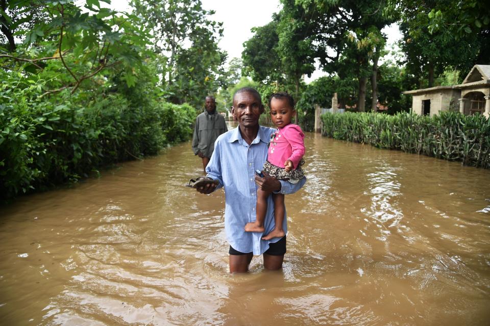 <p>A man walks in street that was flooded in Malfeti, in the city of Fort Liberte in the north east of Haiti, on Sept. 8, 2017, during the passage of Hurricane Irma. (Photo: Hector Retamal /AFP/Getty Images) </p>