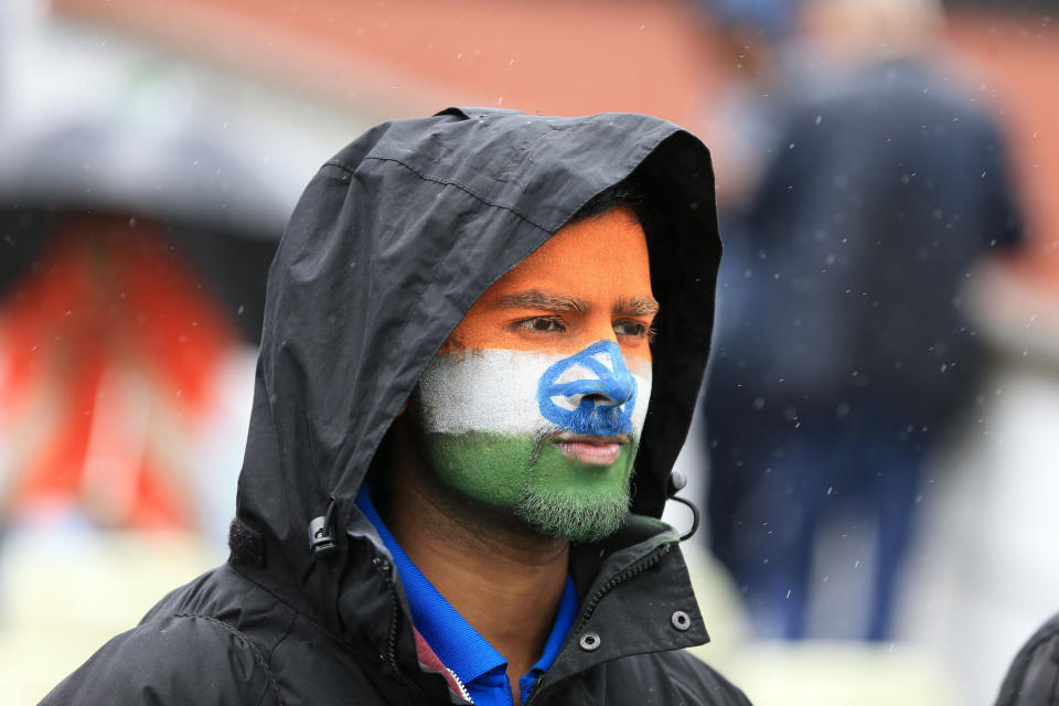 Indian fans shelter from the rain during the ICC Champions Trophy Final at Edgbaston, Birmingham.