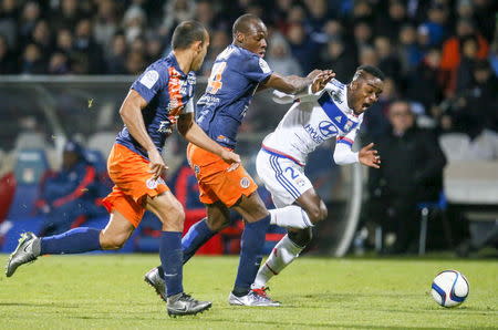 Football Soccer - Olympique Lyon v Montpellier - French Ligue 1 - Gerland stadium, Lyon, France - 27/11/2015 Olympique Lyon's Maxwel Cornet (R) in action against Montpellier's Bryan Dabo (C)REUTERS/Robert Pratta