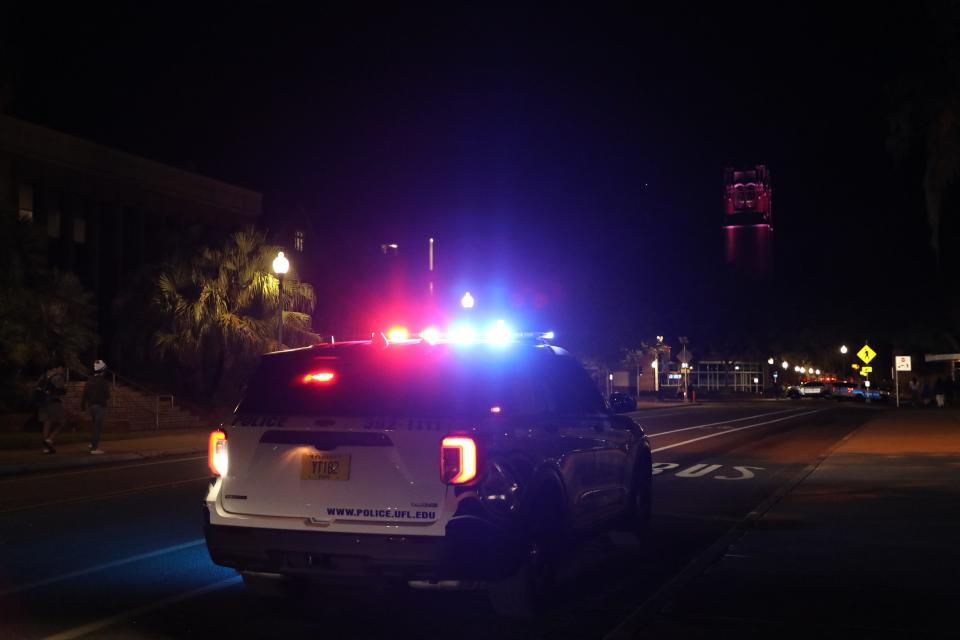 University of Florida police surround Turlington Plaza after the crowd fled from a vigil at the University of Florida on Monday.
