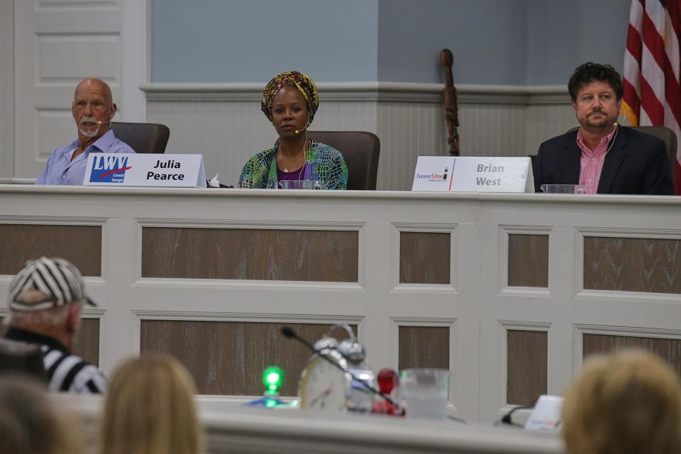The three candidates running to be mayor of Tybee Island, Mack Kitchens (left) Julia Pearce (middle) and Brian West (right) listen and respond to questions about how the would act as mayor during the final mayoral forum on October 4th on Tybee Island.
