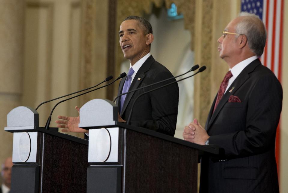 U.S. President Barack Obama speaks as Malaysian Prime Minister Najib Razak listens during a joint news conference at the Prime Minister's Office, in Putrajaya, Malaysia, Sunday, April 27, 2014. (AP Photo/Carolyn Kaster)