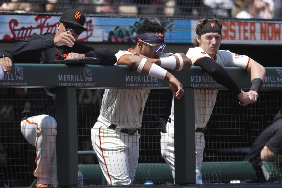 San Francisco Giants' Luis Matos, middle, and Bryce Johnson, right, watch from the dugout during the eighth inning of the team's baseball game against the San Diego Padres in San Francisco, Thursday, June 22, 2023. (AP Photo/Jeff Chiu)