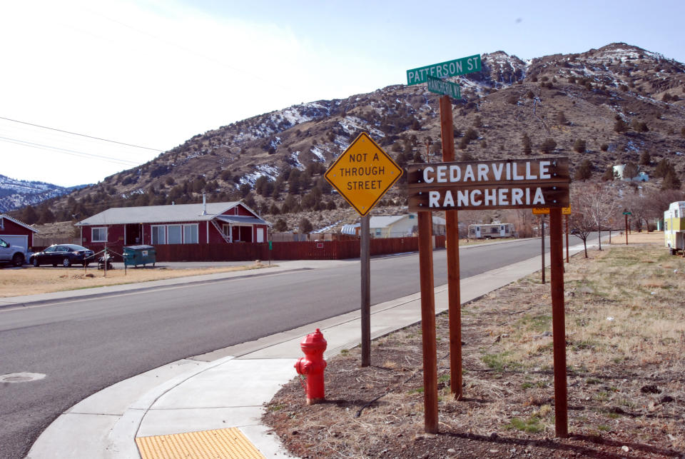 This Feb. 21, 2014 photo shows the entrance to the Cedarville Rancheria, in Cedarville, Calif. Cherie Lash Rhoades, a former chairwoman of the rancheria, lived here. She is held on suspicion of homicide and other counts in a shooting at tribal headquarters in Alturas, Calif., that left four dead and two wounded. (AP Photo/Jeff Barnard)