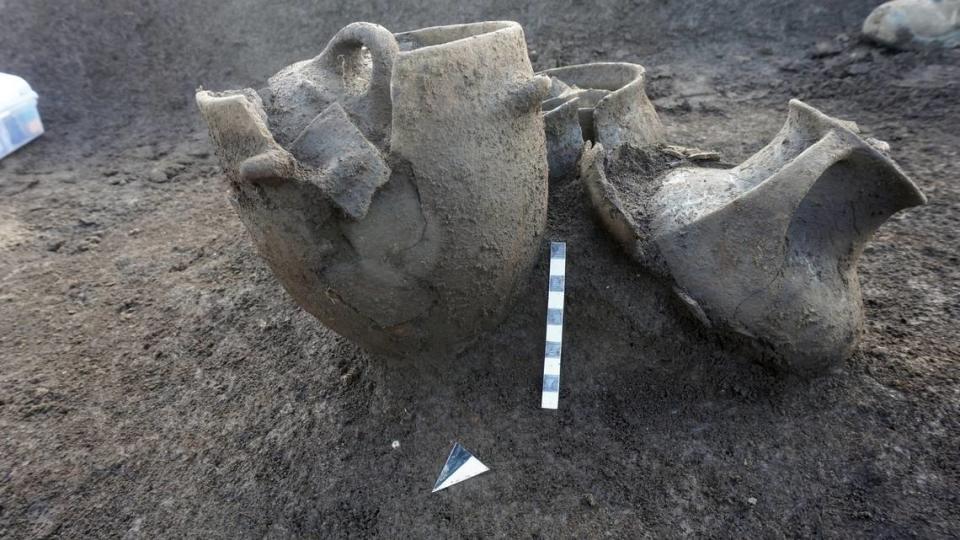 Decorative vases were placed near the feet of some of the human remains, officials said.