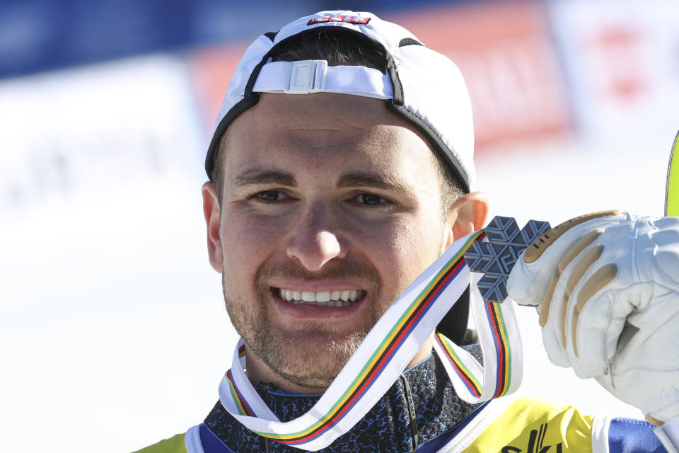 Greece's Aj Ginnis shows the silver medal of the men's World Championship slalom, in Courchevel, France, Sunday Feb. 19, 2023. (AP Photo/Marco Trovati)