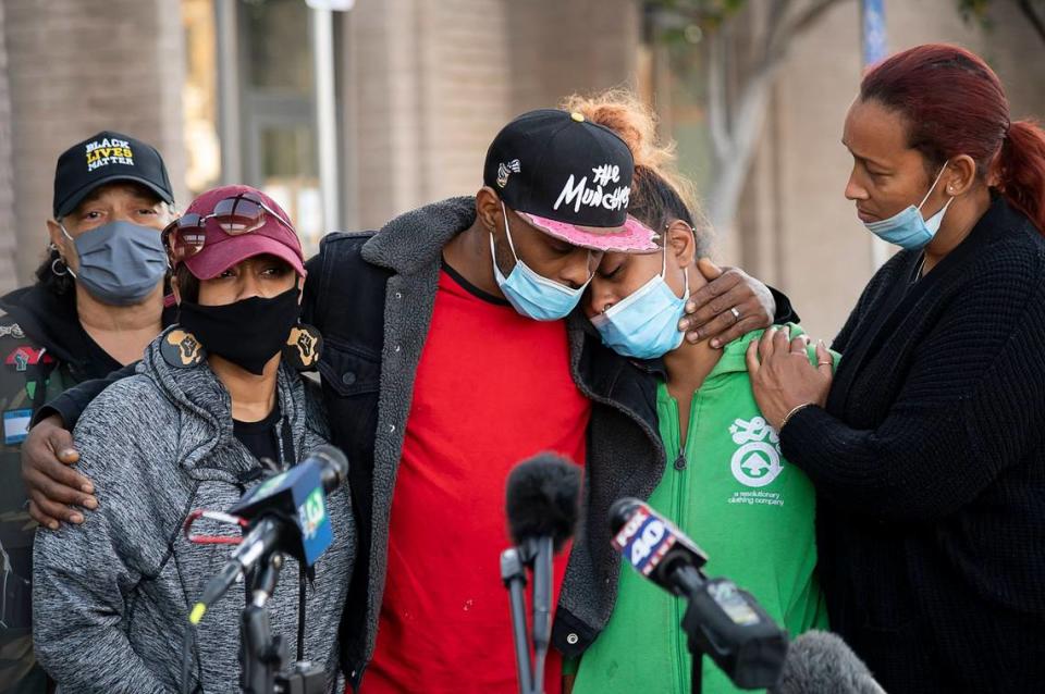 Dwayne and Jayda James, parents of shooting victims Dewayne James Jr., 19, and his brother Sa’Quan Reed-James, 17, console each other with Allegra Taylor, left, Jamilia Land, second from left, and Leia Schenk, right, during a press conference at the Sacramento Public Safety Center on Monday, Nov. 30, after police said they had arrested Damario Beck, 18, as the suspect in the shooting at Arden Fair mall on Friday.