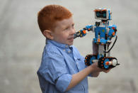 Five year old Tristan poses with a Lego Boost set which forms part of the selection of predicted top sellers this Christmas at the Hamleys toy store in London, Britain, October 12, 2017. REUTERS/Toby Melville