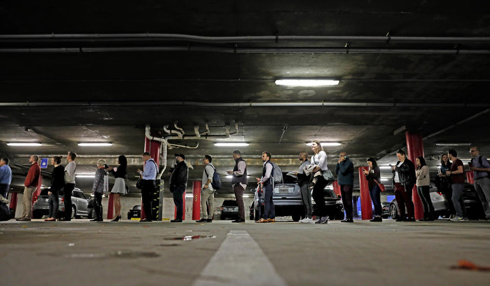 A line backs up into a parking garage outside a polling site on election day in Atlanta, Tuesday, Nov. 6, 2018. (AP Photo/David Goldman)