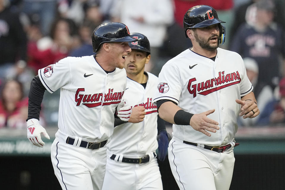 Cleveland Guardians' Myles Straw, Steven Kwan and Mike Zunino, from left, celebrate as they run back to the dugout after scoring on a double by Amed Rosario against the St. Louis Cardinals during the fifth inning of a baseball game Friday, May 26, 2023, in Cleveland. (AP Photo/Sue Ogrocki)