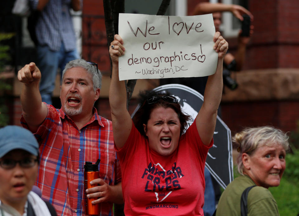 <p>A counter-protester holds a sign near a white nationalist-led rally marking the one year anniversary of the 2017 Charlottesville ‘Unite the Right’protests, in Washington, D.C. August 12, 2018. (Photo: Jim Urquhart/Reuters) </p>