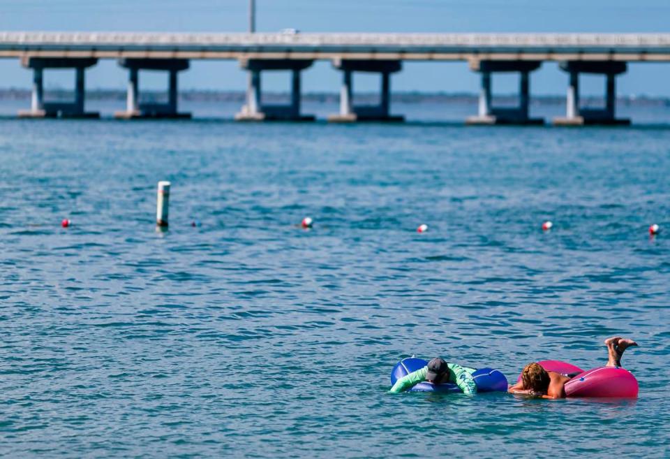 Beachgoers are seen floating off Bahia Honda State Park’s Calusa Beach near Big Pine Key on Monday, Oct. 11, 2021. The Overseas Highway is in the background.