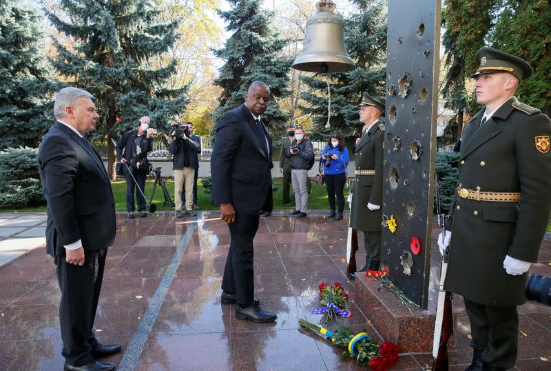 U.S. Defense Secretary Lloyd Austin and Ukrainian Defence Minister Andriy Taran visit a memorial in Kyiv