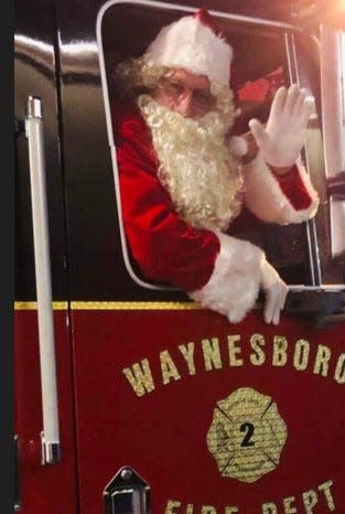 Santa Claus, shown here in 2022, makes his rounds on a fire truck every year in Waynesboro.