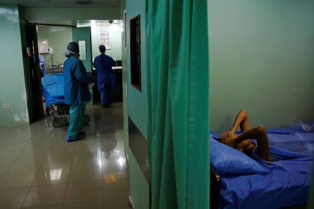 A patient lies in bed while recovers after sterilization surgery in a hospital in Caracas, Venezuela July 27, 2016. REUTERS/Carlos Garcia Rawlins