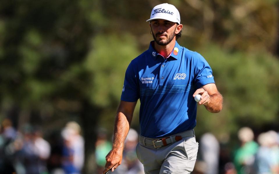 Max Homa shows his ball after hole eight