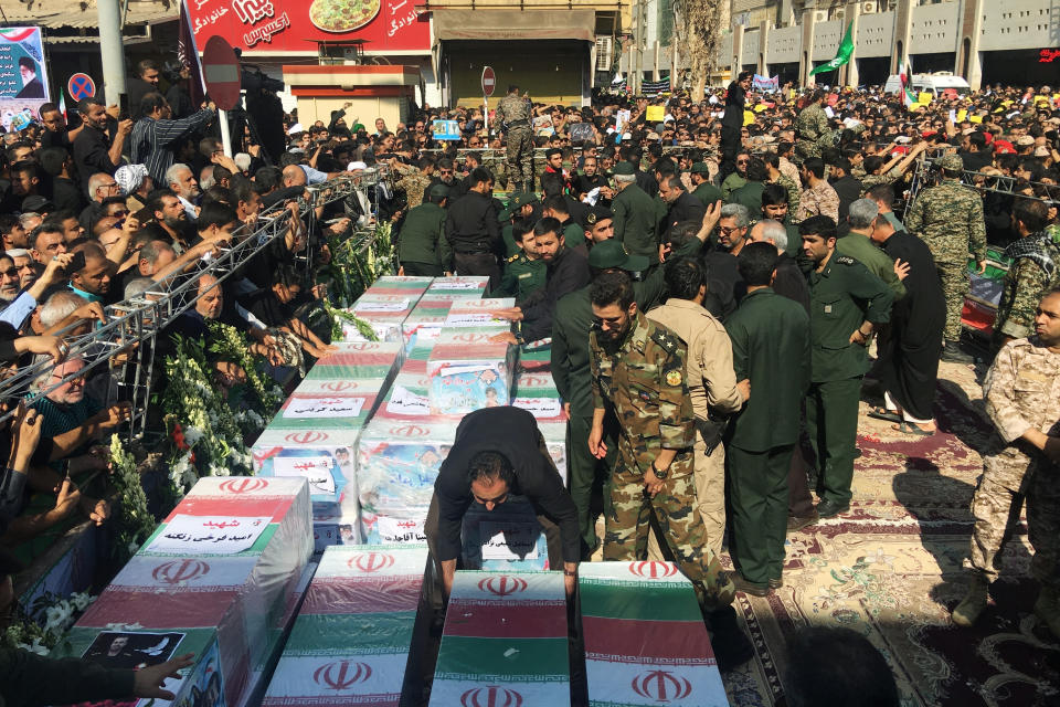 FILE - Caskets of those who died in a terror attack on a military parade in Iran are displayed in Ahvaz, Iran, Sept. 24, 2018. Iran hanged a man who was allegedly behind an attack that killed dozens of people at a military parade in the southern province of Khuzestan in 2018, state media reported on Saturday, May 6, 2023. (AP Photo/Ebrahim Noroozi, File)