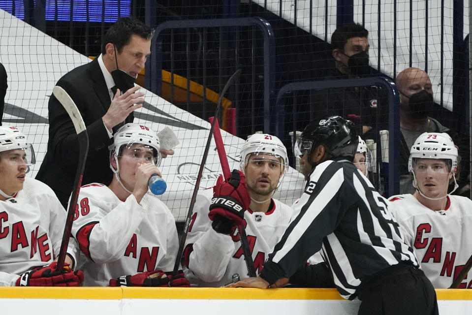 Carolina Hurricanes head coach Rod Brind'Amour, left, questions a call during the first period in Game 4 of an NHL hockey Stanley Cup first-round playoff series against the Nashville Predators Sunday, May 23, 2021, in Nashville, Tenn. (AP Photo/Mark Humphrey)