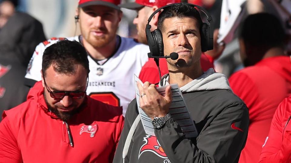 Tampa Bay Buccaneers offensive coordinator Dave Canales, center, stands along the team’s sideline during action against the Carolina Panthers at Bank of America Stadium in Charlotte, NC on Sunday, January 7, 2024. The Buccaneers defeated the Panthers 9-0.