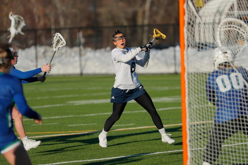 Former Wayland High girls lacrosse standout Abby Stoller prepares to take a shot for Simmons College on March 4, 2022. Stoller is playing lacrosse this spring after being diagnosed with multiple sclerosis in November.