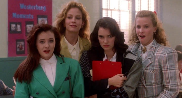 Four teen girls stand together in Heathers.