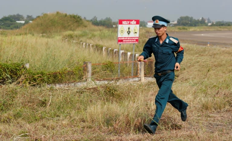 A Vietnamese soldier runs past the dioxin contaminated area on Bien Hoa airbase