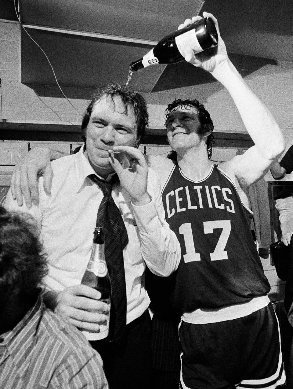 In this May 12, 1974, file photo, Boston Celtic's John Havlicek (17) pours champagne on the head of coach Tom Heinsohn in the dressing room after the Celtics 102-87 win over Milwaukee Bucks to win the NBA basketball championship in Milwaukee, Wis. Heinsohn is one of 12 finalists up for election into the Basketball Hall of Fame, the hall of fame announced Friday, Feb. 15, 2013. The 2013 class will be announced at the Final Four in April. (AP Photo/File)