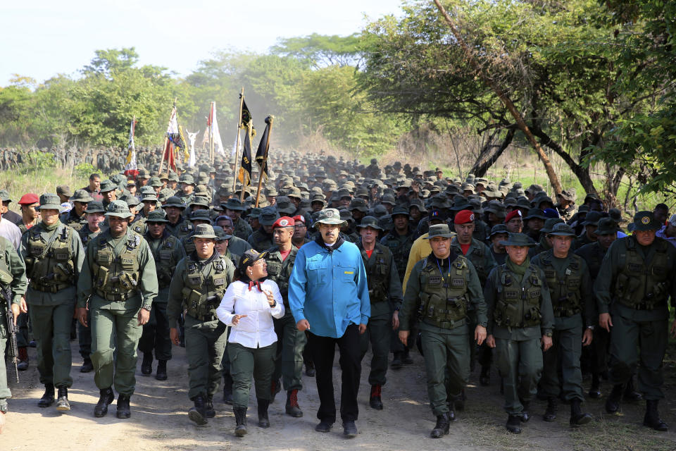 In this handout photo released by Miraflores Press Office, Venezuela's President Nicolas Maduro walks with troops at the G/J José Laurencio Silva training center in the state of Cojedes, Venezuela, Saturday, May 4, 2019. (Jhonn Zerpa/Miraflores Press Office via AP)