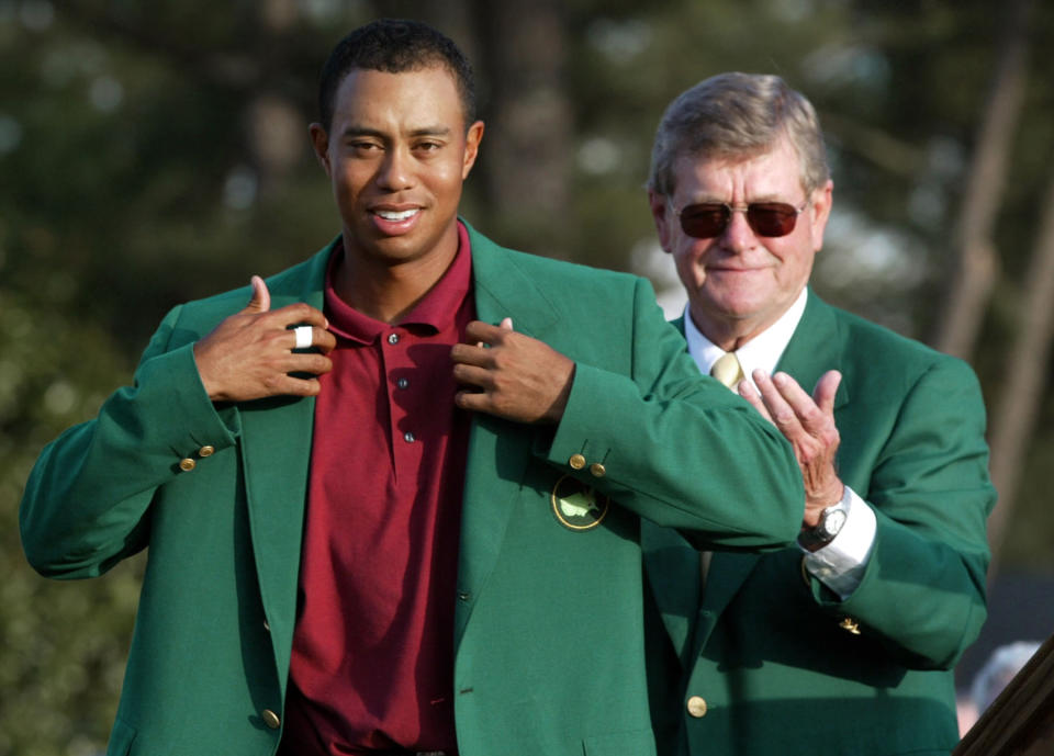 <p>Tiger Woods, left, adjusts the 2002 Masters Green Jacket he received from Augusta National Golf Club chairman William W.”Hootie” Johnson, as Johnson applauds at the Augusta National Golf Club in Augusta, Ga. Woods intends to remain out of golf at least until the Masters, two people with knowledge of his plans have told The Associated Press on Thursday, march 11, 2010. The two people, who spoke on condition of anonymity because only Woods is supposed to release such information, say he is likely to play first at Augusta National in April. (AP Photo/Doug Mills, File) </p>