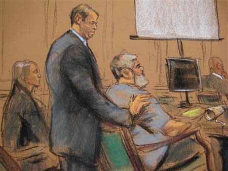 Defense Attorney Joshua Dratel rests his hands on the shoulders of Abu Hamza al-Masir (R), the radical Islamist cleric facing U.S. terrorism charges, as he sits next to defense attorney Lindsay Lewis (L) in Manhattan federal court in New York in this artist's sketch, April 17, 2014. REUTERS/Jane Rosenberg