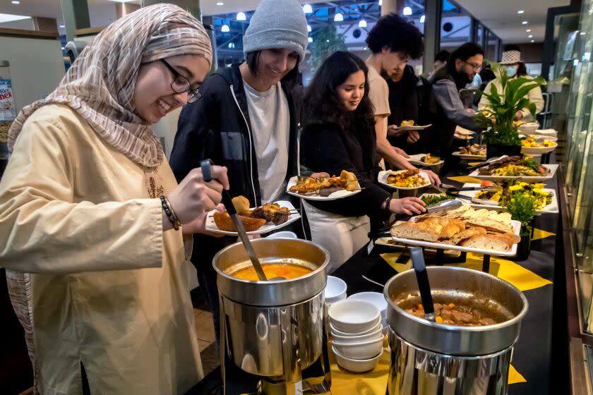 CLAREMONT, CA - APRIL 06: Scripps students Reema Iqbal, Hena Ahmed, a Harvey Mudd student Leila Bensaid, Fares Marzouk, a Pomona College student and other students, after breaking their Ramadan fast partake specially prepared halal meal for Muslims at Harvey Mudd College on Thursday, April 6, 2023 in Claremont, CA. (Irfan Khan / Los Angeles Times)