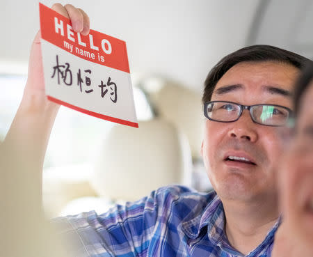 Yang Hengjun, author and former Chinese diplomat, who is now an Australian citizen, display a name tag in an unspecified location in Tibet, China, mid-July, 2014 in this social media image obtained by REUTERS/Files